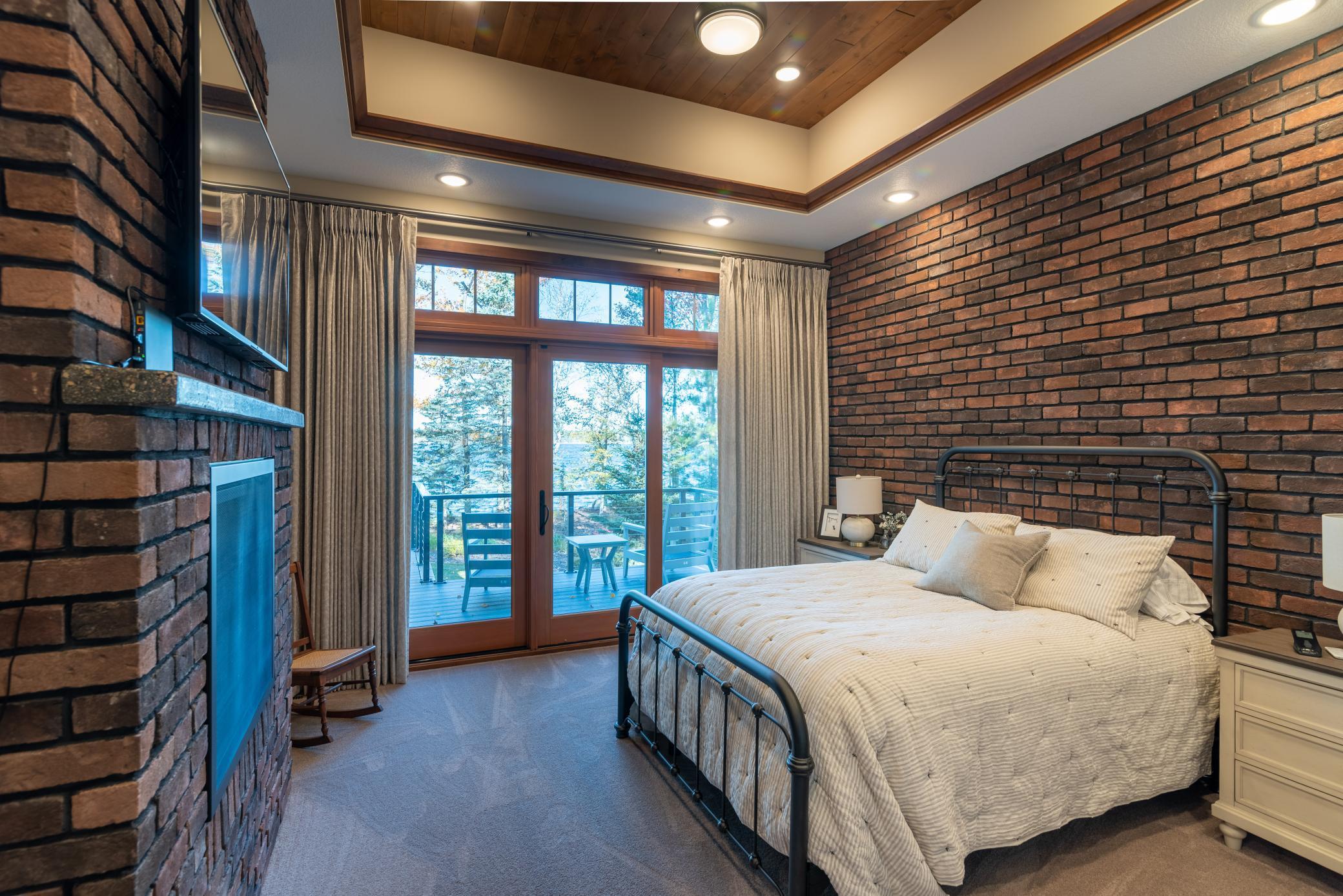 Motorized drapes, fireplace, patio doors to the lakeside expansive deck!