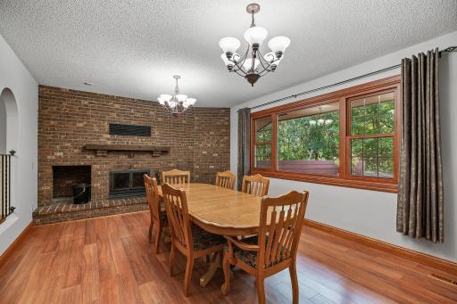 Living room or currently used as a formal dining space. Features wood burning fireplace.