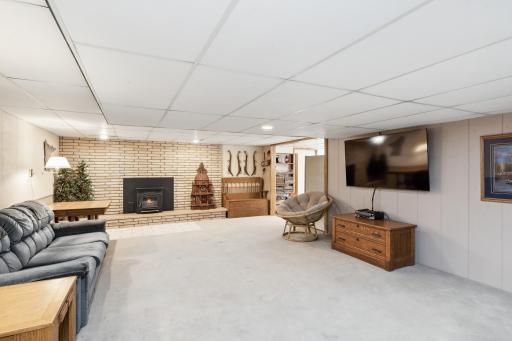The lower level offers a large amusement room with brick fireplace and installed wood pellet stove, which is a great source of heat. The floors are heated in this room.