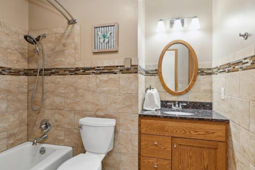 There is a separate newly updated full bath with ceramic-tile surround and granite countertops accessed from the great room and the hallway.