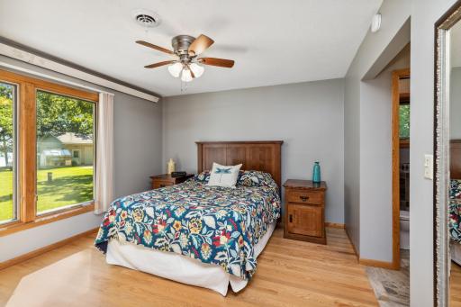 The owners suite has oak floors, an updated 3/4 bath with slate/ceramic tile, glass block, granite countertops, and a lovely walk-in closet.