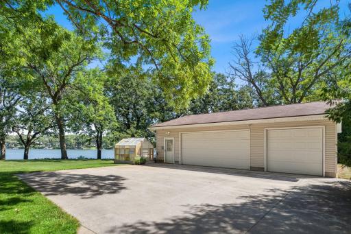 Detached insulated and in floor-heated 36x30 garage with vinyl siding, double and single garage doors and concrete driveway, exterior water spigot, water softener, and new boiler.