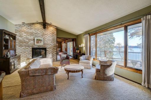 Vaulted Living room with wall of windows and see thru fireplace.
