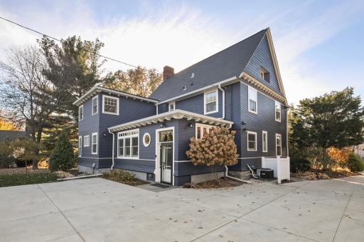 4639 Fremont Ave S - Rear of the home showing work from 2019: residing of 3/4 of home, painted exterior, and concrete driveway