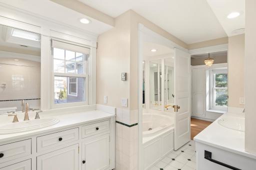 4639 Fremont Ave S - Hall and primary bath includes 2 vanities, jetted tub, and separate shower