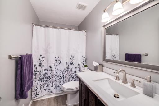 Photo for 8251 169th Street W, Lakeville, MN 55044 - Listing #6307744 Remodeled upper level, full bathroom. New comfort height stool, solid surface vanity, mirror, light and luxury vinyl plank flooring.