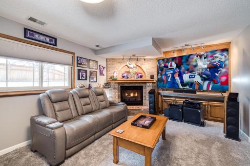 Photo for 8251 169th Street W, Lakeville, MN 55044 - Listing #6307744 Family room with a decorative brick, gas fireplace with solid wood built-in's. Brand new frieze carpet with upgraded pad replaced in June of 2022. New window treatment.