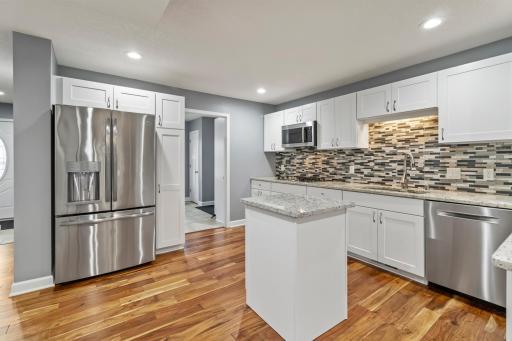Kitchen with granite countertop and tile backsplash