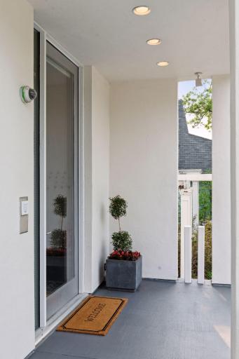 The oversized glass entry door immediately introduces you to the architecture inside.