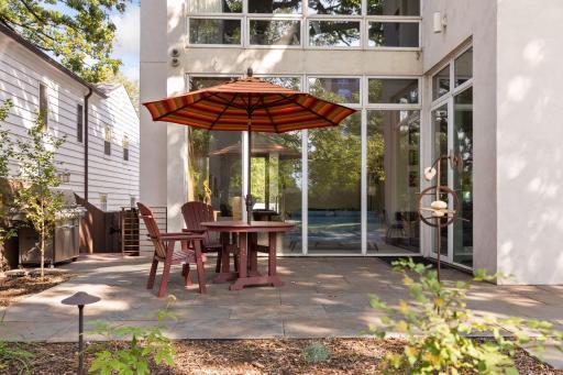The back yard patio has this dining area with a plumbed grill here and a second seating area with a plumbed fire pit.