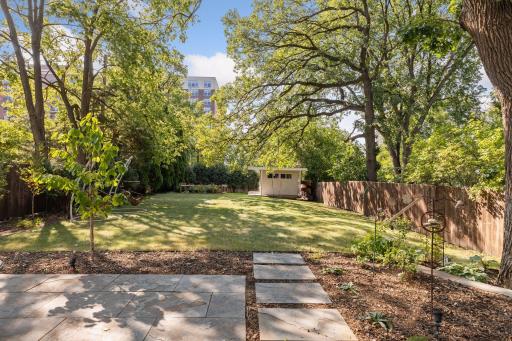 The yard is large and features raised vegetable beds and a garden shed.