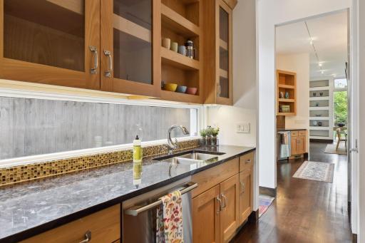 A modern Butler's pantry with lots of work space and connection to the kitchen and beyond.