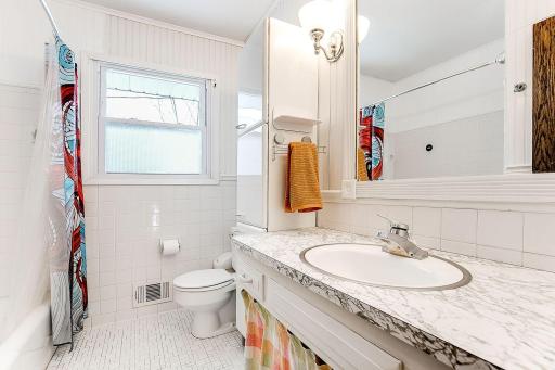Bathroom is nice sized and has some retro cabinets that provide so much extra linen storage, nice bath and shower.