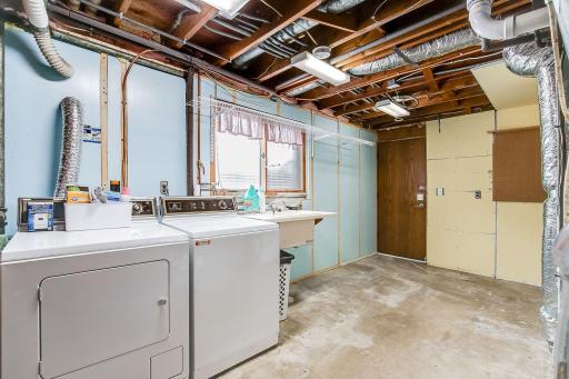 Laundry room has great storage space. There is also a ton of space under the stairs in the lower level.