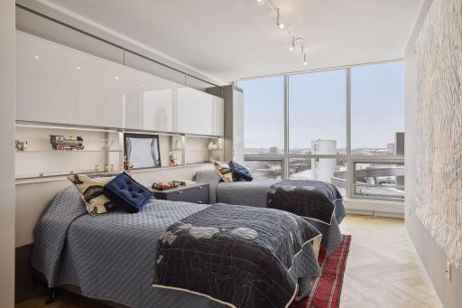 Upper level guest bedroom with built-in cabinetry and closets. Sunrise views to the East.
