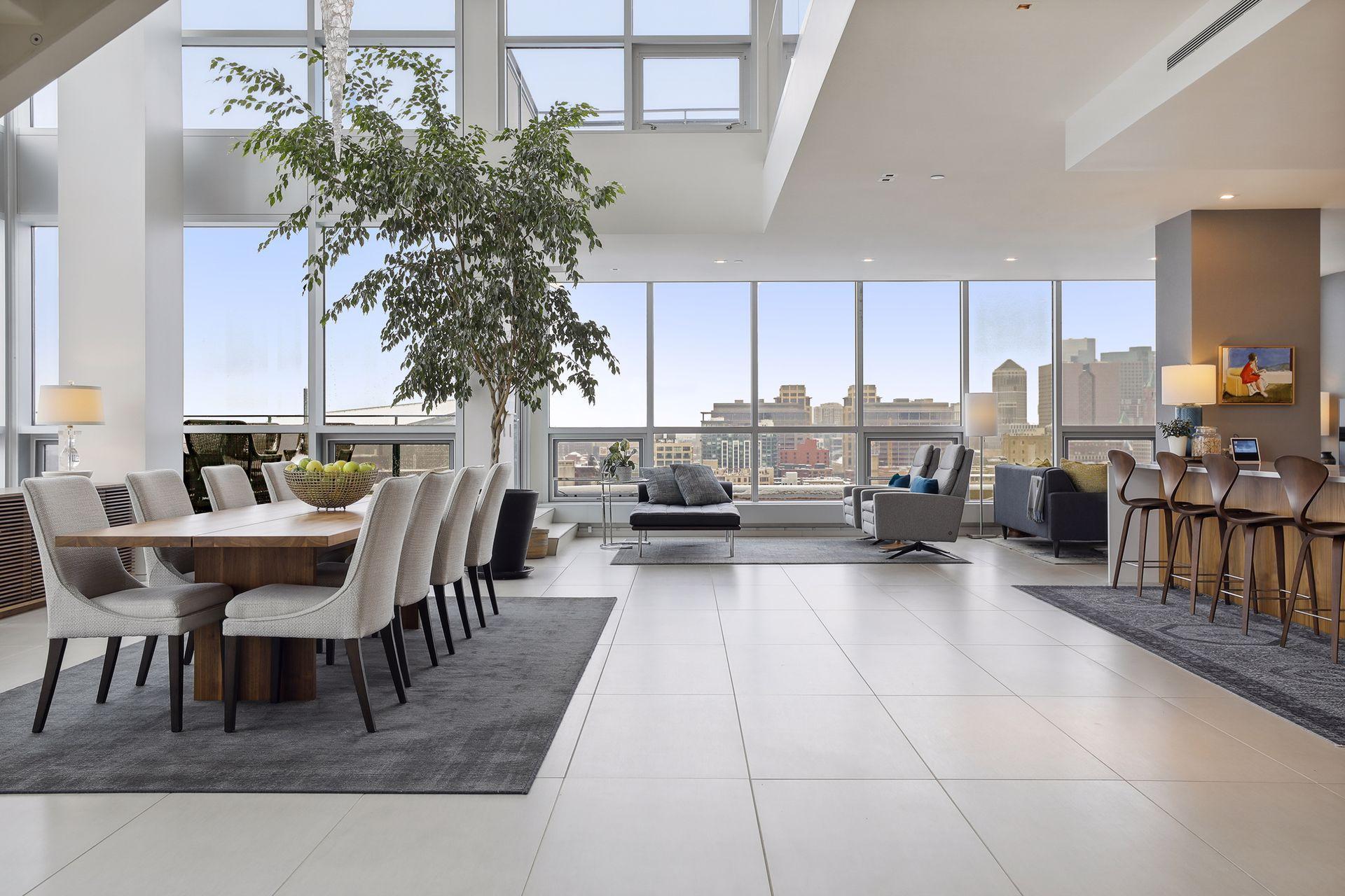 Dining, kitchen, and lounge area with views to the south and east. A large outdoor terrace at the SE corner is easily accessed through french doors from the lounge area.