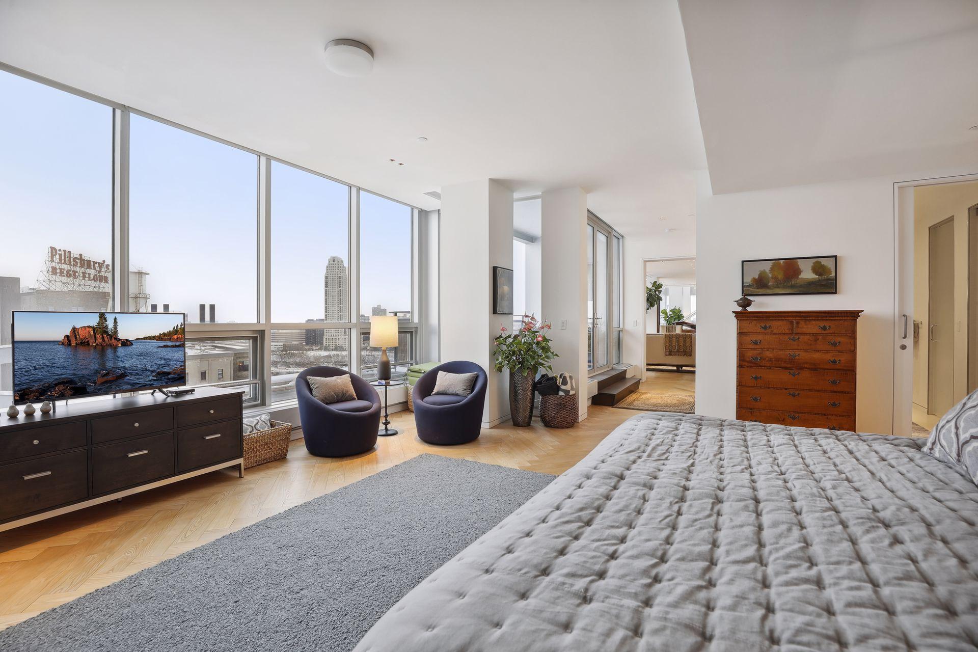 The main level bedroom suite faces East and enjoys sunrises, riverfront views to the Southeast, and Saint Paul landmarks in the distance.