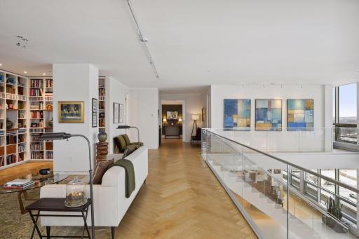 The upper level also offers excellent wall space for art collections to be displayed. A glass half wall was designed to maximize natural light and ensure unobstructed views.