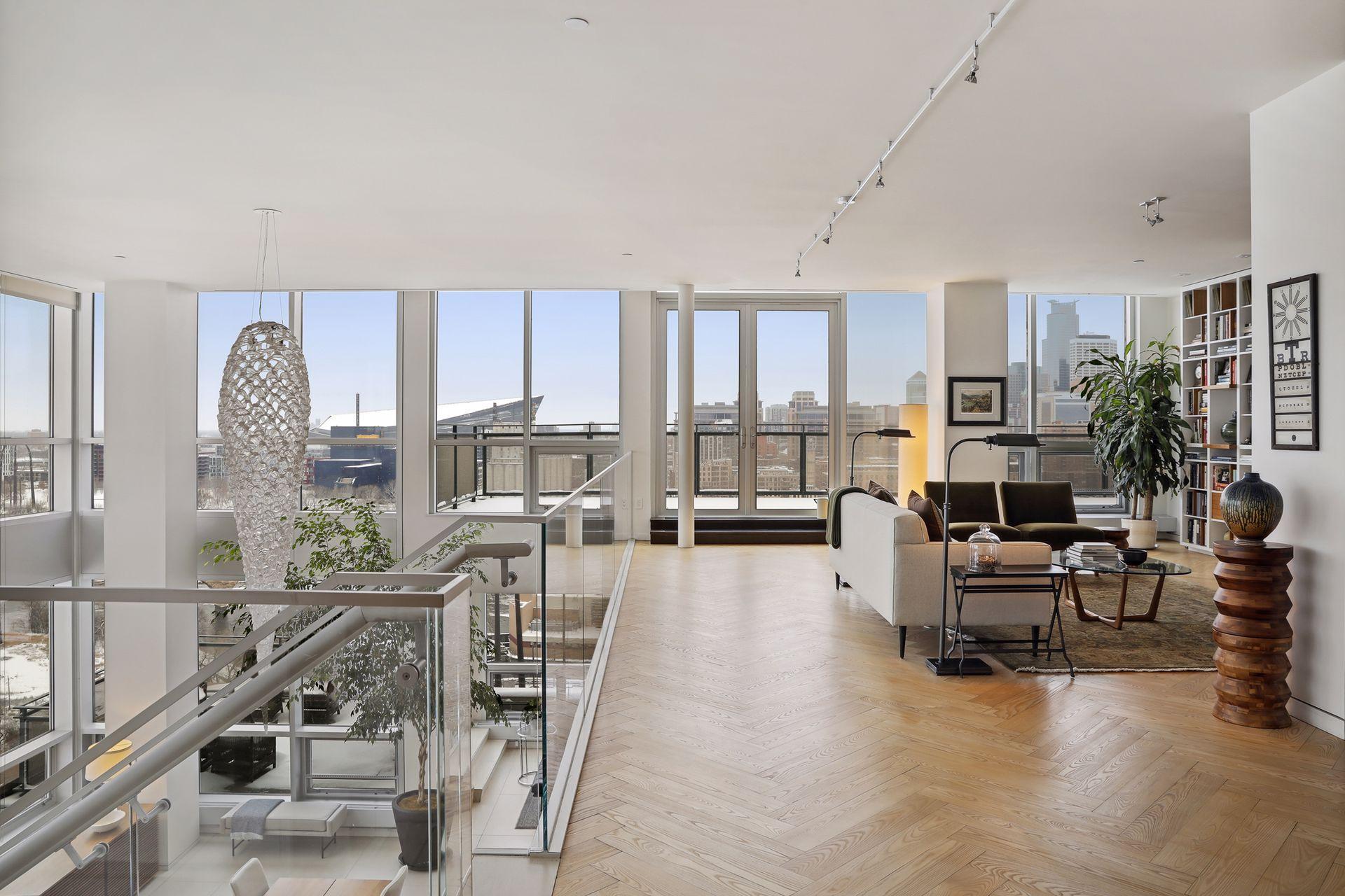 French doors lead to the upper level terrace adjacent to the library and den. Beautiful black ash herringbone floors throughout the upper level living and bedroom areas.