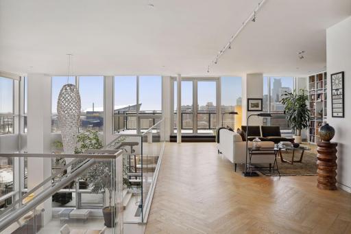 French doors lead to the upper level terrace adjacent to the library and den. Beautiful black ash herringbone floors throughout the upper level living and bedroom areas.