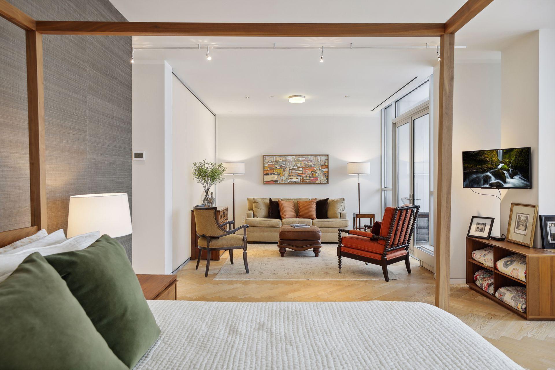 A cozy sitting room within the primary bedroom suite with access to a private outdoor terrace.