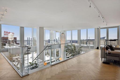 Extraordinary views from the upper level library and den through two stories of windows.
