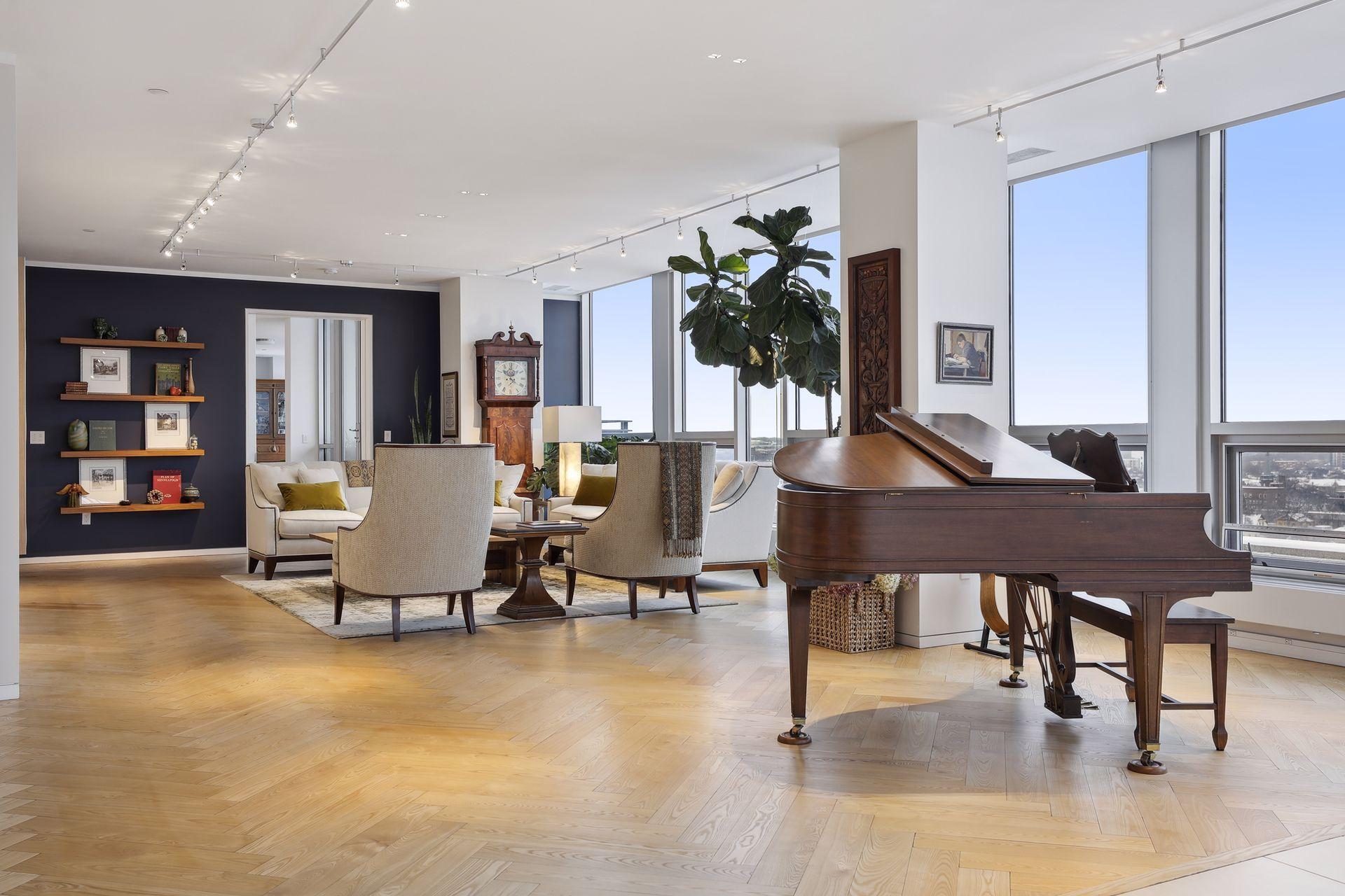 Main level formal living area featuring solid black ash herringbone floors that extend into the main level primary bedroom suite.