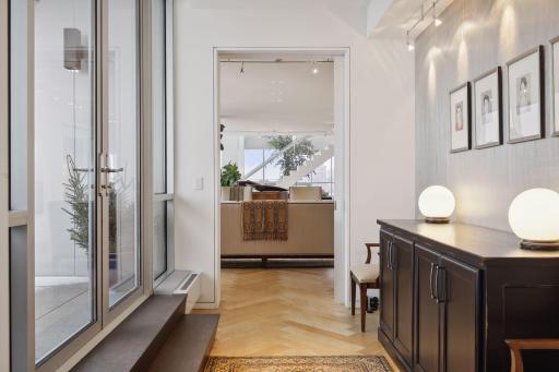 An etched glass pocket door and wide entry hall provides privacy and separation from the living area for the main level bedroom suite.