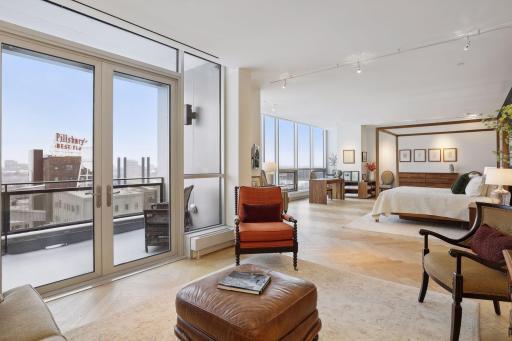 Upper level primary bedroom suite with a sitting room, private terrace, sunrise views to the East and riverfront views to the South East.