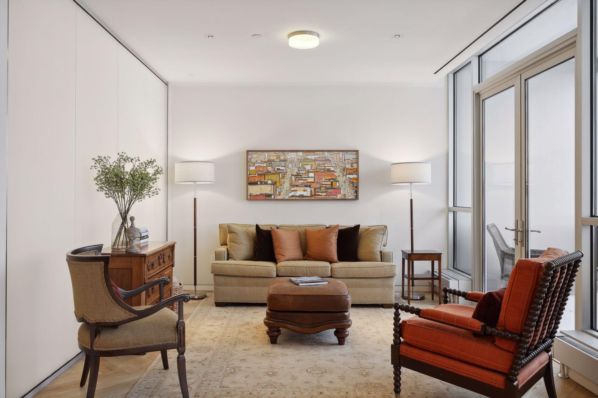 Primary bedroom suite sitting area. An etched glass wall on the left side provides natural light to filter into the en suite bath.