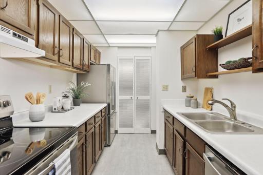 Stainless steel appiances include a stove, refrigerator and dishwasher.