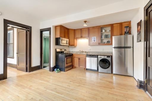 The kitchen area features granite countertops, updated SS appliances including a combo Washer & Dryer!