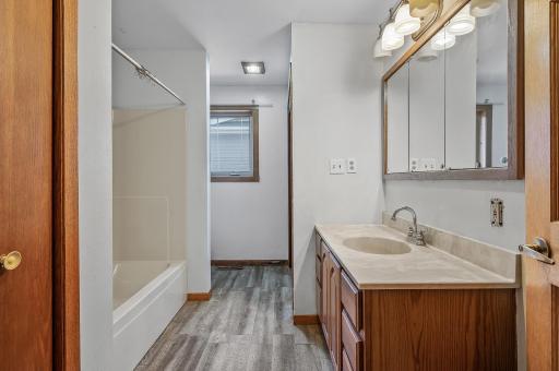 Full bathroom with shower/tub combo in house #1.