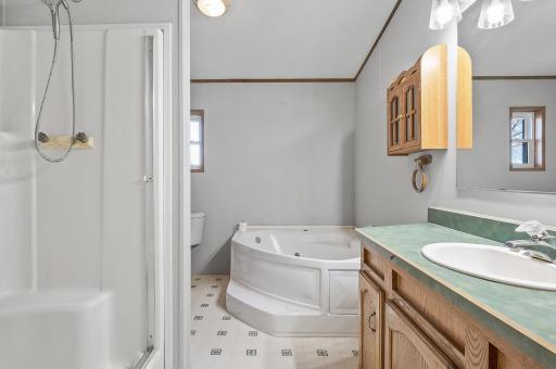 Full bathroom in house #2 with corner jetted tub.