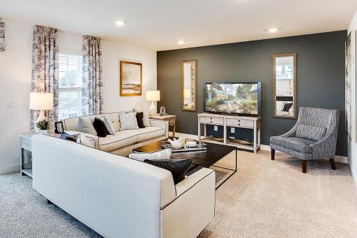 The super comfortable living room has plenty of space for the whole family! Photo of end unit model, colors are similar.
