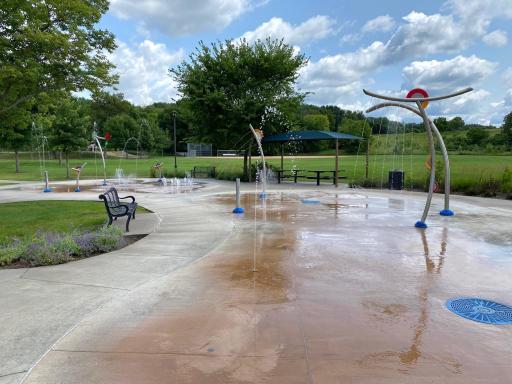 Within walking distance, Highlands Park offers year-round fun, including this summertime favorite splash pad!