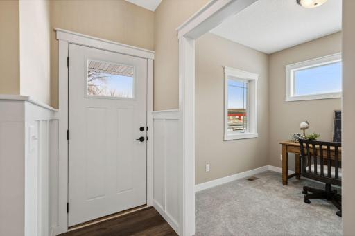 The front foyer welcomes you with tons of natural light and a private office to your left