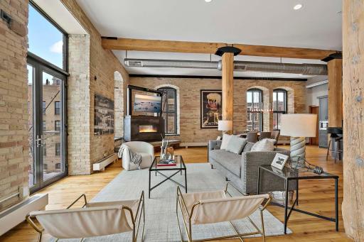 Living room space includes hardwood floors, fireplace and expansive space.