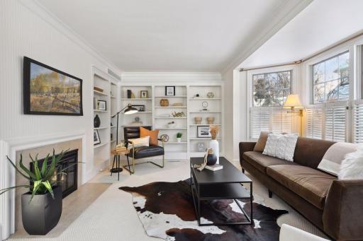 Oversized den shares the fireplace with the living room
