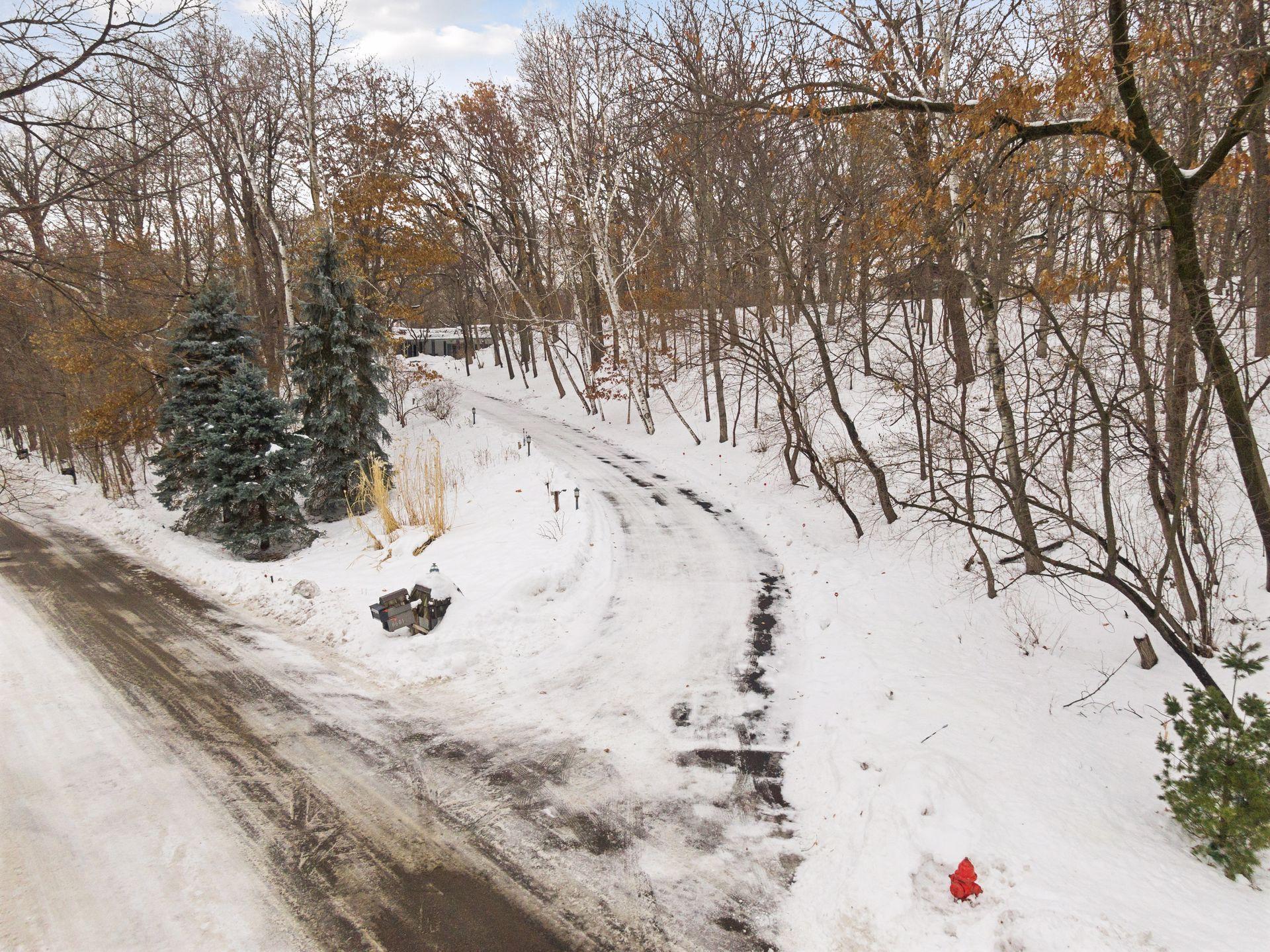 Driveway to 6601 Mohawk Trail which is the lot to be divided. Note the survey stakes are to the left of the 3 evergreen trees. Other stakes are near the fire hydrant to the right.