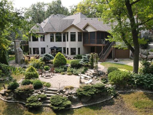 Impressive rear view showcasing the tremendous hardscape in the backyard.