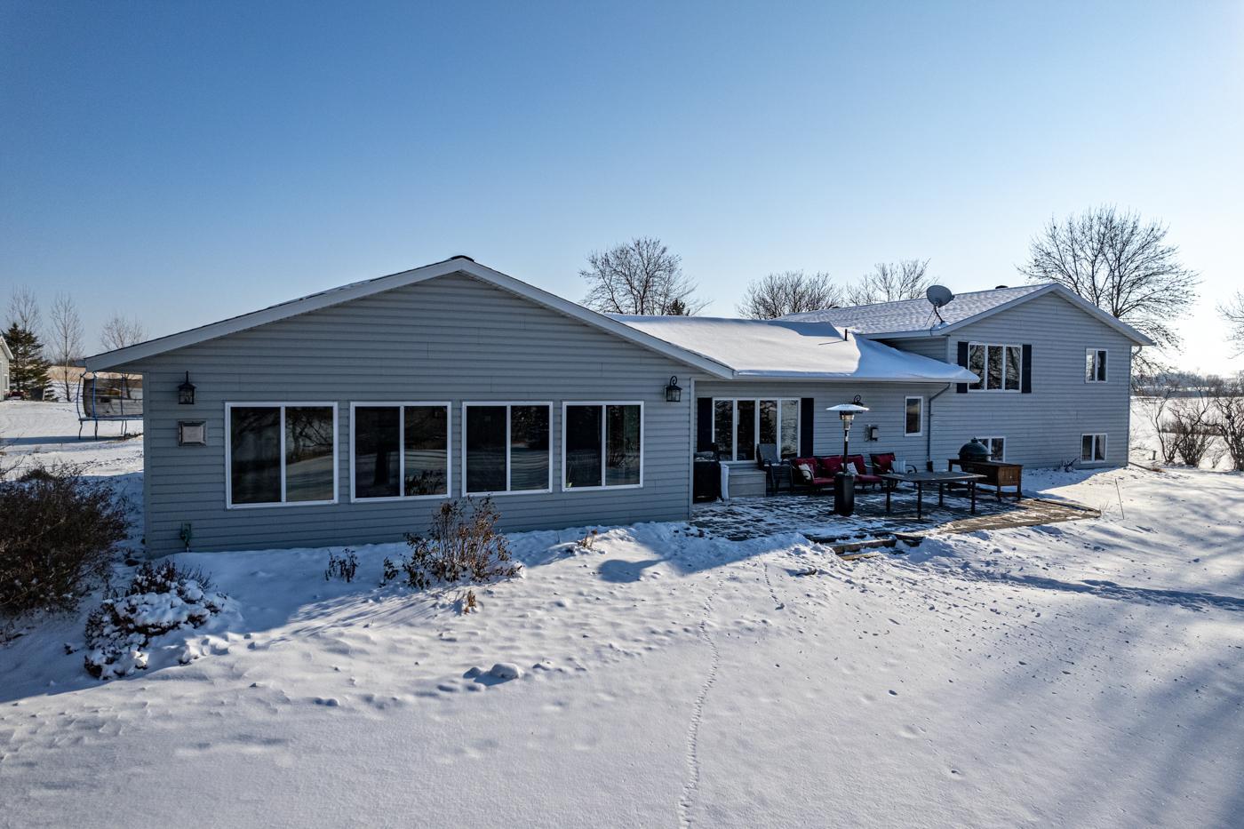back of home with sunroom windows