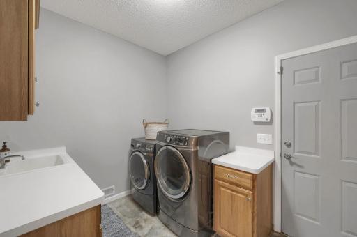 Bright main floor laundry/mudroom area as you enter from the heated 4 stall garage.