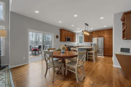 Spacious informal dining area separates the great room from kitchen and steps out to the new maintenance free deck.