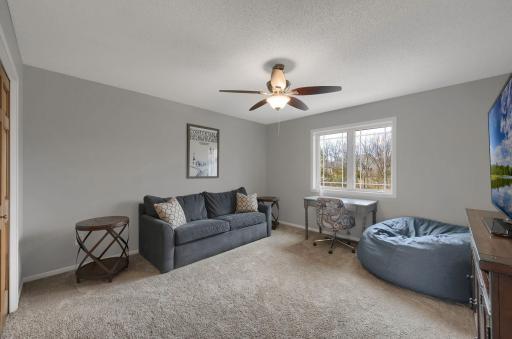 Second bedroom on upper level is being used as a lounge area.