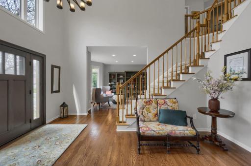Welcome guests in the grand two story foyer! Hardwood floors flow throughout entire main level. New front door and foyer window above is equipped with powered blinds.