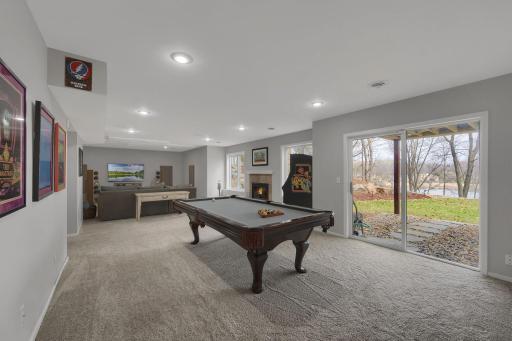 Plenty of space for a pool table or other game of your choice. Lower level is roughed in for a bar on the left wall pictured here. Walkout to wonderful landscaping and views of the lake!
