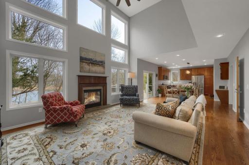 No shortage of natural light in the two story great room with floor to ceiling windows offering views of Saunders Lake.