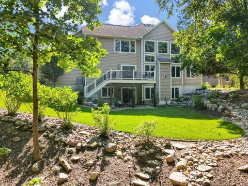 Gorgeous landscaping surrounds the home. There is a sprinkler system and level backyard for yard games.