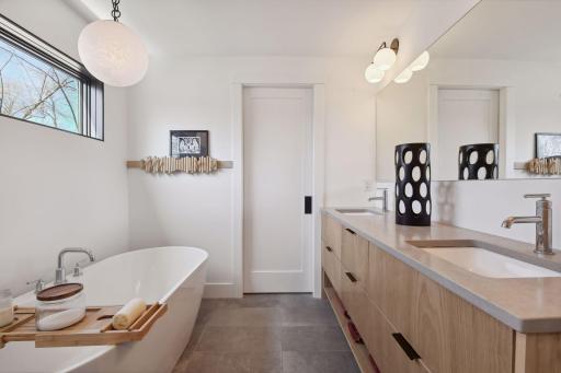 The Primary Bathroom features heated tile flooring and a comfort-height vanity with quartz countertops.